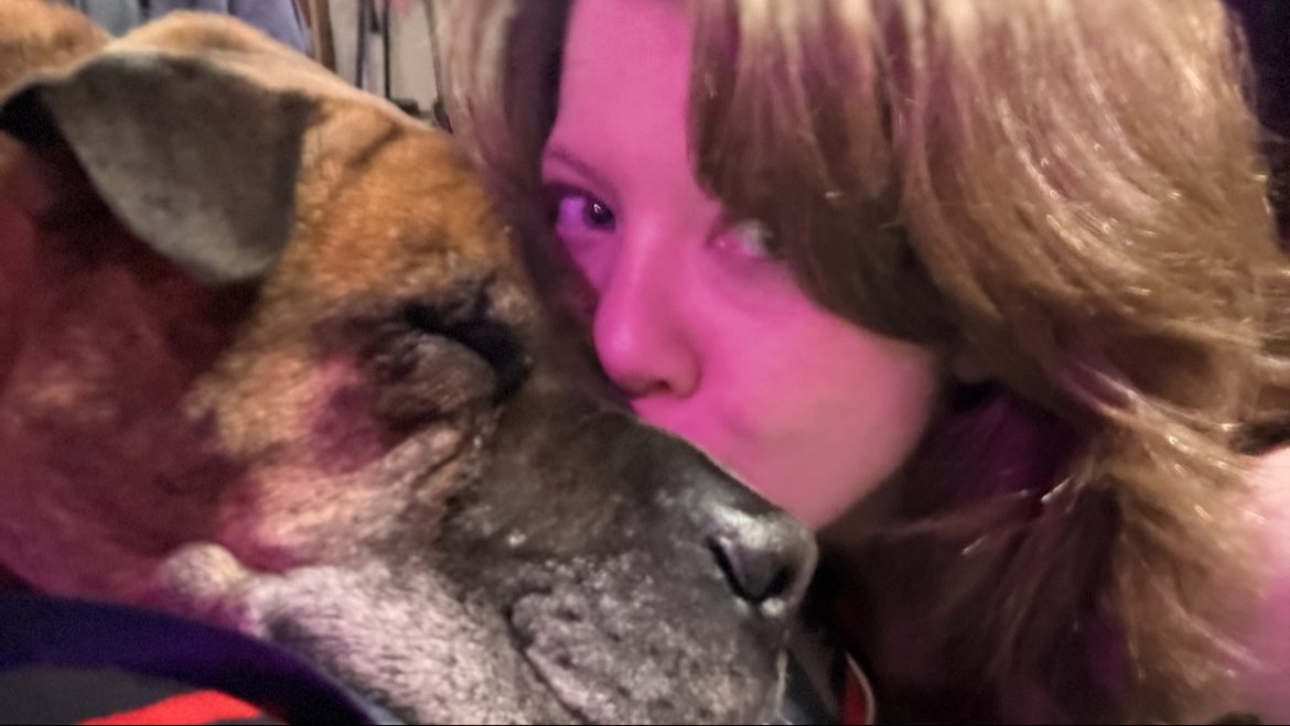 Em kissing Bane, her senior brindle dog